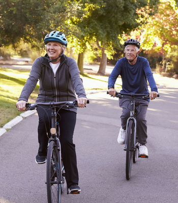 Image of older adults biking outside