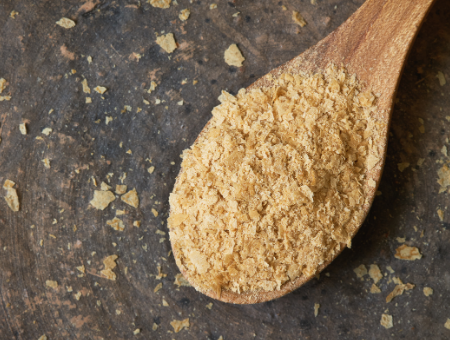 wooden spoon filled with yeast beta glucan